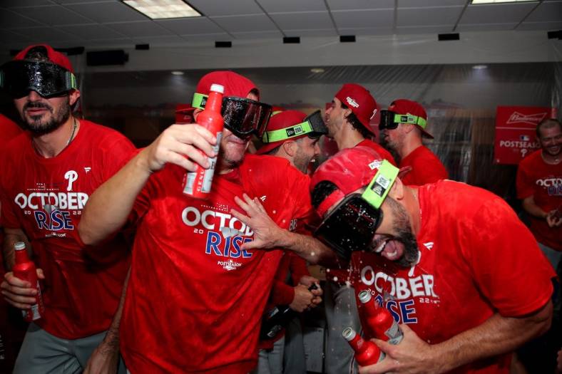 Oct 3, 2022; Houston, Texas, USA; Members of the Philadelphia Phillies celebrate in the locker room following a 3-0 victory over the Houston Astros at Minute Maid Park. Philadelphia clinched a National League Wild Card berth with the win. Mandatory Credit: Erik Williams-USA TODAY Sports