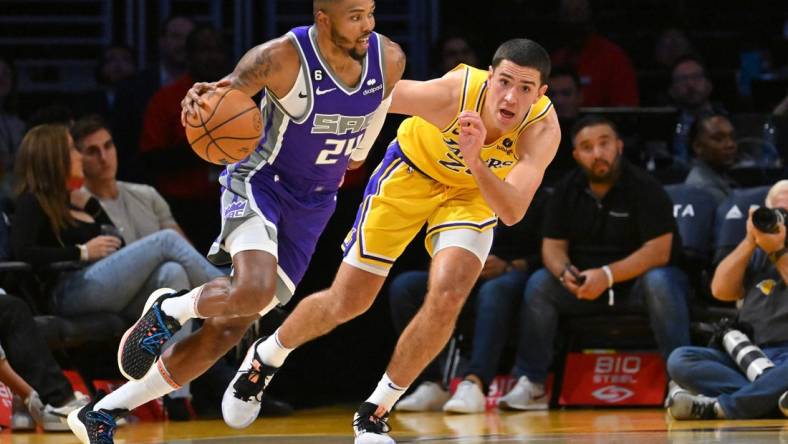 Oct 3, 2022; Los Angeles, California, USA; Sacramento Kings forward Kent Bazemore (24) drives to the basket as he is defended by Los Angeles Lakers forward Cole Swider (20) in the second half at Crypto.com Arena. Mandatory Credit: Jayne Kamin-Oncea-USA TODAY Sports