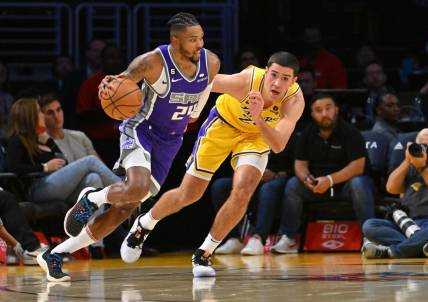 Oct 3, 2022; Los Angeles, California, USA; Sacramento Kings forward Kent Bazemore (24) drives to the basket as he is defended by Los Angeles Lakers forward Cole Swider (20) in the second half at Crypto.com Arena. Mandatory Credit: Jayne Kamin-Oncea-USA TODAY Sports