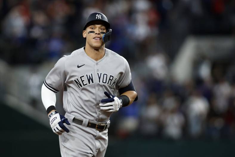 Oct 4, 2022; Arlington, Texas, USA; New York Yankees right fielder Aaron Judge (99) rounds the bases after hitting home run #62 to break the American League home run record in the first inning against the Texas Rangers at Globe Life Field. Mandatory Credit: Tim Heitman-USA TODAY Sports
