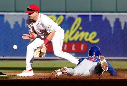 Oct 5, 2022; Cincinnati, Ohio, USA; Chicago Cubs shortstop Nico Hoerner (2) steals second against Cincinnati Reds second baseman Spencer Steer (12) during the second inning at Great American Ball Park. Mandatory Credit: David Kohl-USA TODAY Sports