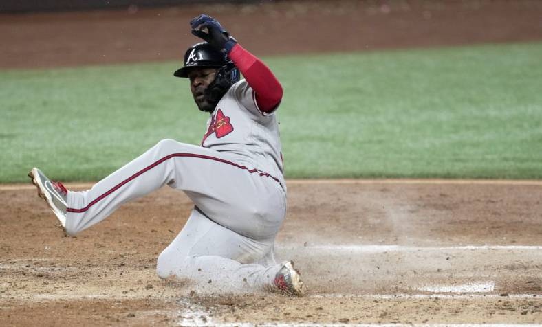 Oct 5, 2022; Miami, Florida, USA; Atlanta Braves center fielder Guillermo Heredia (38) scores in the third inning against the Miami Marlins at loanDepot Park. Mandatory Credit: Jim Rassol-USA TODAY Sports