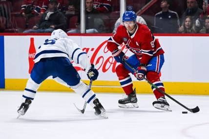 Oct 3, 2022; Montreal, Quebec, CAN; Montreal Canadiens defenseman Mike Matheson (8) plays the puck against Toronto Maple Leafs center Alexander Kerfoot (15) during the third period at Bell Centre. Mandatory Credit: David Kirouac-USA TODAY Sports