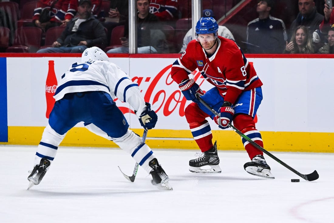 Oct 3, 2022; Montreal, Quebec, CAN; Montreal Canadiens defenseman Mike Matheson (8) plays the puck against Toronto Maple Leafs center Alexander Kerfoot (15) during the third period at Bell Centre. Mandatory Credit: David Kirouac-USA TODAY Sports