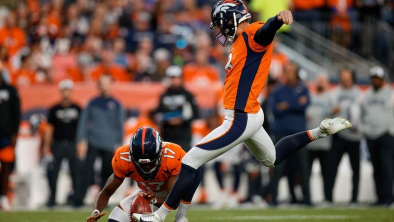 Oct 6, 2022; Denver, Colorado, USA; Denver Broncos place kicker Brandon McManus (8) kicks a field goal on a hold from punter Corliss Waitman (17) in the first quarter against the Indianapolis Colts at Empower Field at Mile High. Mandatory Credit: Isaiah J. Downing-USA TODAY Sports