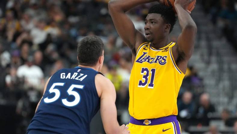 Oct 6, 2022; Las Vegas, Nevada, USA; Los Angeles Lakers center Thomas Bryant (31) looks to pass the ball as Minnesota Timberwolves center Luka Garza (55) defends during a preseason game at T-Mobile Arena. Mandatory Credit: Stephen R. Sylvanie-USA TODAY Sports