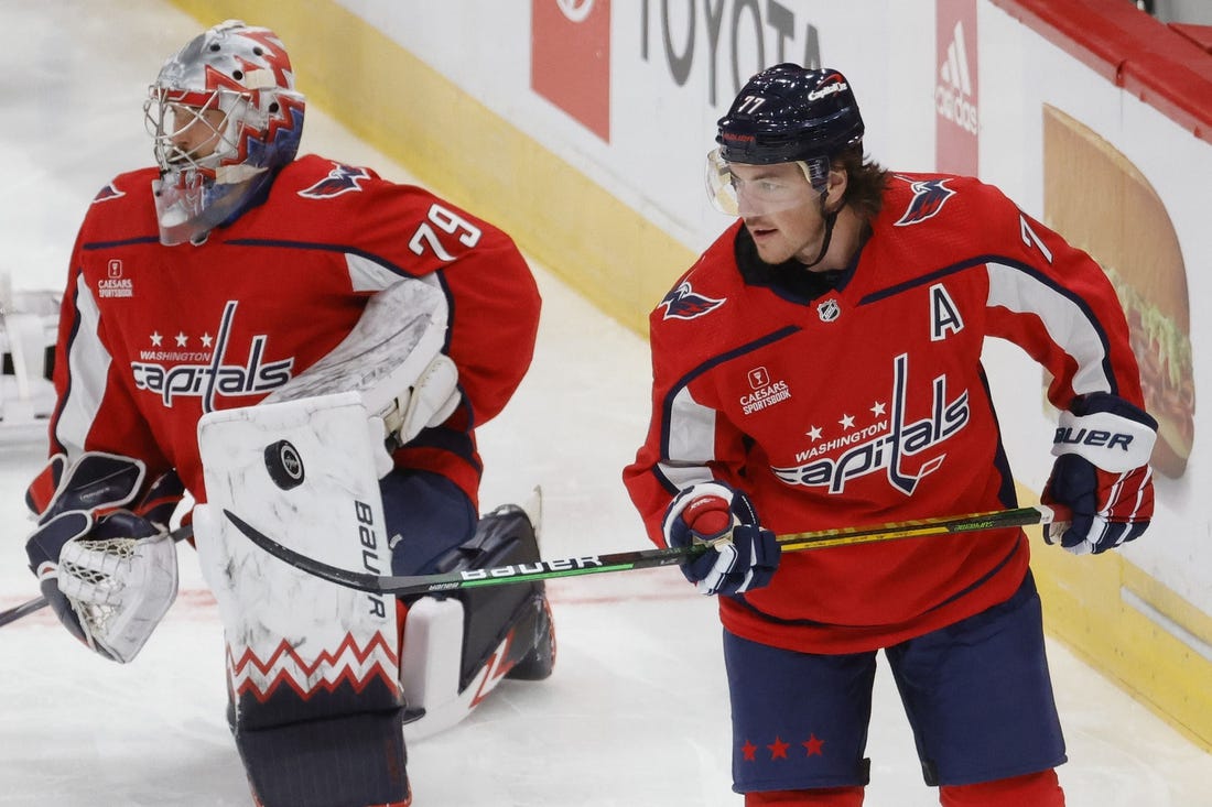 Oct 5, 2022; Washington, District of Columbia, USA; Washington Capitals right wing T.J. Oshie (77) juggles a puck with his stick in front of Capitals goaltender Charlie Lindgren (79) on ice prior to the Capitals' game against the Detroit Red Wings at Capital One Arena. Mandatory Credit: Geoff Burke-USA TODAY Sports