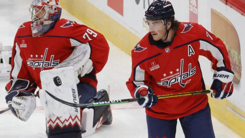 Oct 5, 2022; Washington, District of Columbia, USA; Washington Capitals right wing T.J. Oshie (77) juggles a puck with his stick in front of Capitals goaltender Charlie Lindgren (79) on ice prior to the Capitals' game against the Detroit Red Wings at Capital One Arena. Mandatory Credit: Geoff Burke-USA TODAY Sports