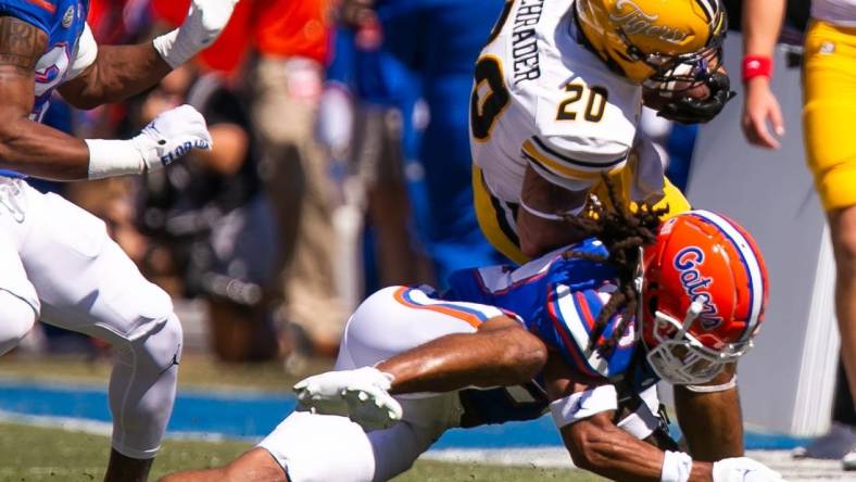 Florida Gators safety Corey Collier Jr. (20) tackles Missouri Tigers running back Cody Schrader (20) in the first half at Steve Spurrier Field at Ben Hill Griffin Stadium in Gainesville, FL on Saturday, October 8, 2022. [Doug Engle/Gainesville Sun]

Ncaa Football Florida Gators Vs Missouri Tigers