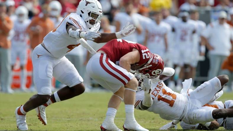 Oklahoma Sooners wide receiver Drake Stoops (12) is brought down by Texas Longhorns defensive back Austin Jordan (4) and Texas Longhorns defensive back Anthony Cook (11) during the Red River Showdown college football game between the University of Oklahoma (OU) and Texas at the Cotton Bowl in Dallas, Saturday, Oct. 8, 2022.

Lx16259