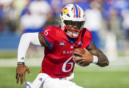 Oct 8, 2022; Lawrence, Kansas, USA; Kansas Jayhawks quarterback Jalon Daniels (6) runs with the ball during the first half against the TCU Horned Frogs at David Booth Kansas Memorial Stadium. Mandatory Credit: Jay Biggerstaff-USA TODAY Sports