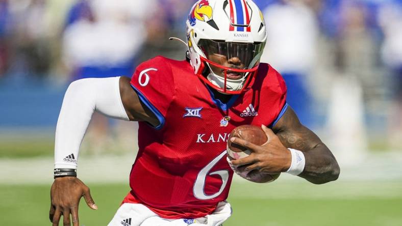 Oct 8, 2022; Lawrence, Kansas, USA; Kansas Jayhawks quarterback Jalon Daniels (6) runs with the ball during the first half against the TCU Horned Frogs at David Booth Kansas Memorial Stadium. Mandatory Credit: Jay Biggerstaff-USA TODAY Sports