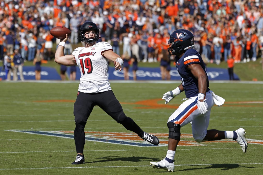 Oct 8, 2022; Charlottesville, Virginia, USA; Louisville Cardinals quarterback Brock Domann (19) passes the ball as Virginia Cavaliers linebacker Nick Jackson (6) chases during the second quarter at Scott Stadium. Mandatory Credit: Geoff Burke-USA TODAY Sports