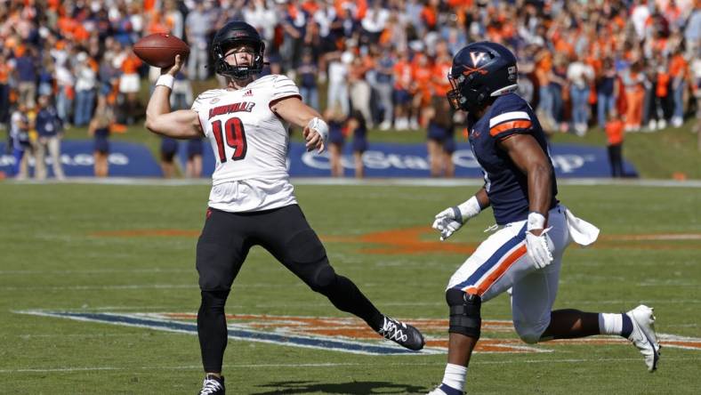 Oct 8, 2022; Charlottesville, Virginia, USA; Louisville Cardinals quarterback Brock Domann (19) passes the ball as Virginia Cavaliers linebacker Nick Jackson (6) chases during the second quarter at Scott Stadium. Mandatory Credit: Geoff Burke-USA TODAY Sports