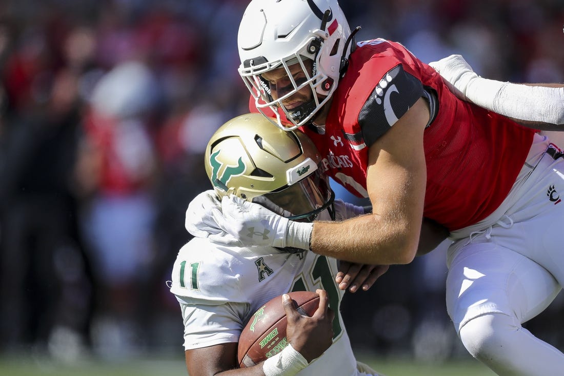 Oct 8, 2022; Cincinnati, Ohio, USA; Cincinnati Bearcats linebacker Wilson Huber (2) sacks South Florida Bulls quarterback Gerry Bohanon (11) in the first half at Nippert Stadium. Mandatory Credit: Katie Stratman-USA TODAY Sports