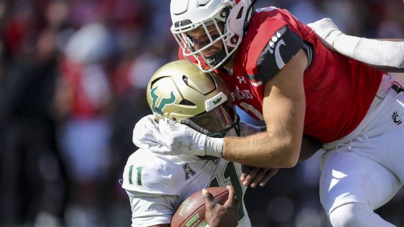 Oct 8, 2022; Cincinnati, Ohio, USA; Cincinnati Bearcats linebacker Wilson Huber (2) sacks South Florida Bulls quarterback Gerry Bohanon (11) in the first half at Nippert Stadium. Mandatory Credit: Katie Stratman-USA TODAY Sports