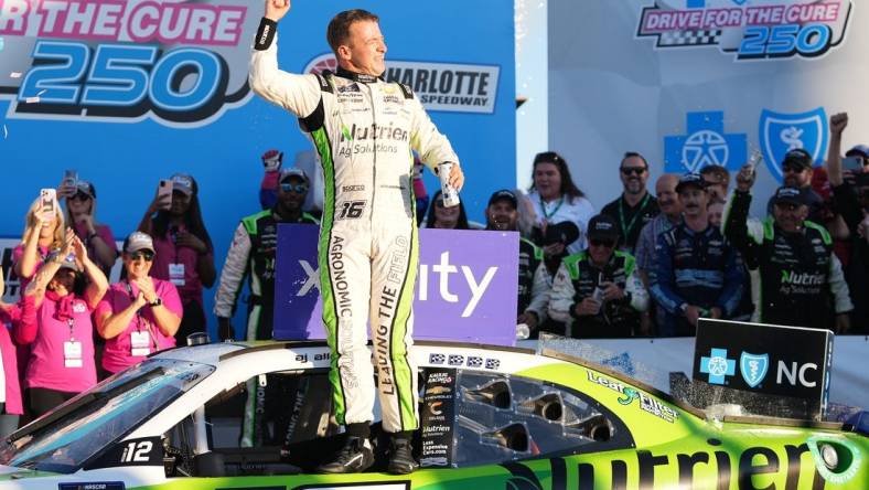 Oct 8, 2022; Concord, North Carolina, USA; NASCAR Xfinity Series driver AJ Allmendinger (16) celebrates after winning the Drive for the Cure 250 at Charlotte Motor Speedway Road Course. Mandatory Credit: Jasen Vinlove-USA TODAY Sports