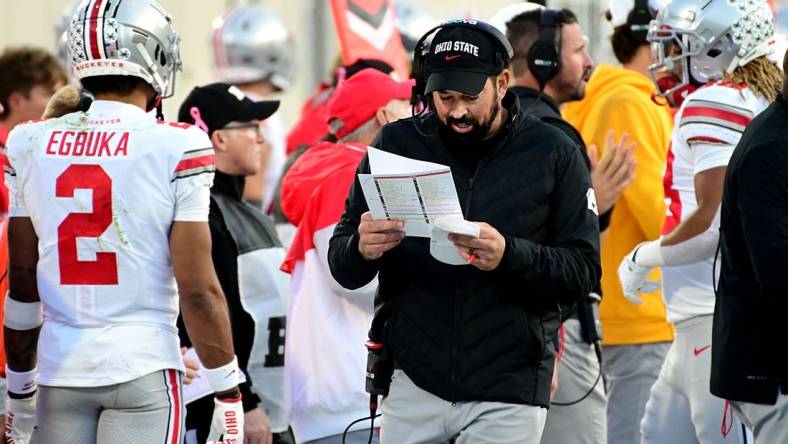 Oct 8, 2022; East Lansing, Michigan, USA;  Ohio State Buckeyes head coach Ryan Day calls plays on the sidelines against the Michigan State Spartans in the fourth quarter at Spartan Stadium. Mandatory Credit: Dale Young-USA TODAY Sports