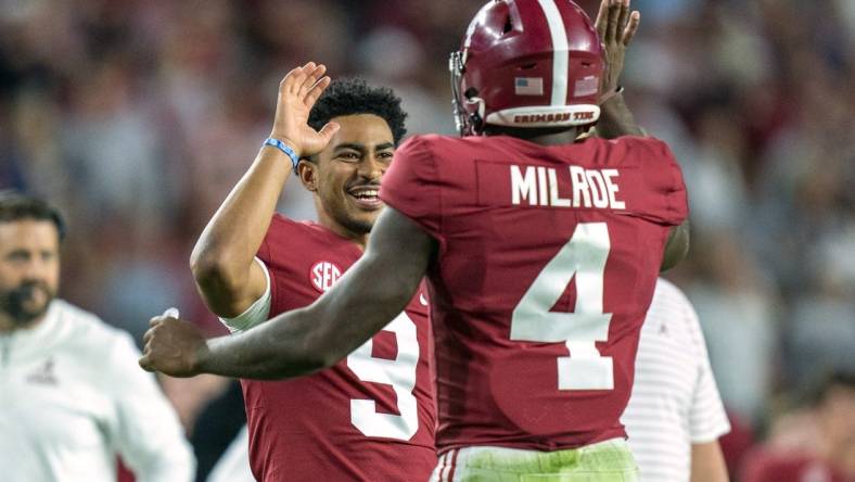 Oct 8, 2022; Tuscaloosa, Alabama, USA; Alabama Crimson Tide quarterback Jalen Milroe (4) celebrates with quarterback Bryce Young (9) after scoring a touchdown against the Texas A&M Aggies during the first half at Bryant-Denny Stadium. Mandatory Credit: Marvin Gentry-USA TODAY Sports