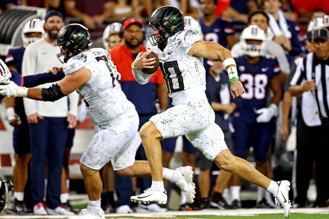 Oct 8, 2022; Tucson, Arizona, USA; Oregon Ducks quarterback Bo Nix (10) runs the ball during the second half against the Arizona Wildcats at Arizona Stadium. Mandatory Credit: Mark J. Rebilas-USA TODAY Sports