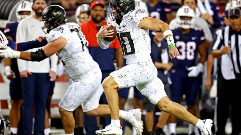 Oct 8, 2022; Tucson, Arizona, USA; Oregon Ducks quarterback Bo Nix (10) runs the ball during the second half against the Arizona Wildcats at Arizona Stadium. Mandatory Credit: Mark J. Rebilas-USA TODAY Sports