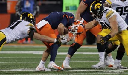 Oct 8, 2022; Champaign, Illinois, USA;  Iowa Hawkeyes defensive lineman Luke Gaffney (51) and defensive lineman Lukas Van Ness (91) tackle Illinois Fighting Illini quarterback Tommy DeVito (3) during the first half at Memorial Stadium. DeVito was injured on the play. Mandatory Credit: Ron Johnson-USA TODAY Sports