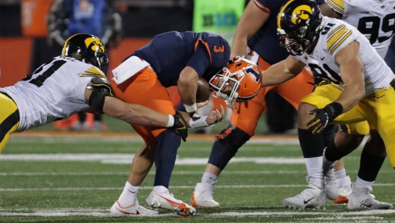 Oct 8, 2022; Champaign, Illinois, USA;  Iowa Hawkeyes defensive lineman Luke Gaffney (51) and defensive lineman Lukas Van Ness (91) tackle Illinois Fighting Illini quarterback Tommy DeVito (3) during the first half at Memorial Stadium. DeVito was injured on the play. Mandatory Credit: Ron Johnson-USA TODAY Sports