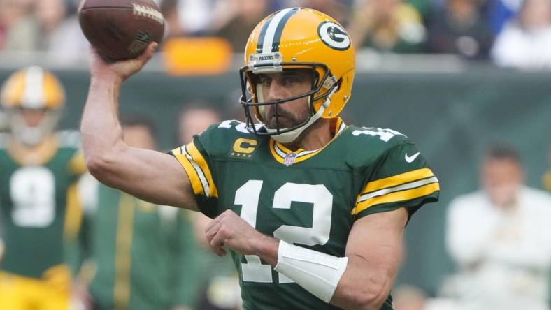 Oct 9, 2022; London, United Kingdom; Green Bay Packers quarterback Aaron Rodgers (12) throws the ball in the first quarter against the New York Giants during an NFL International Series game at Tottenham Hotspur Stadium. Mandatory Credit: Kirby Lee-USA TODAY Sports