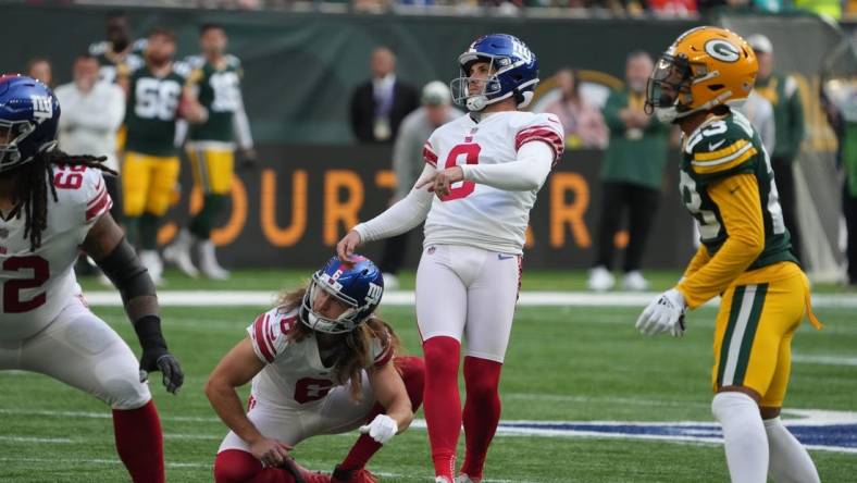 Oct 9, 2022; London, United Kingdom; New York Giants place kicker Graham Gano (9) kicks a field goal out of the hold of punter Jamie Gillan (6) in the first half against the Green Bay Packers during an NFL International Series game at Tottenham Hotspur Stadium. Mandatory Credit: Kirby Lee-USA TODAY Sports