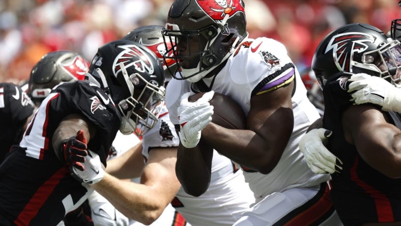 Oct 9, 2022; Tampa, Florida, USA; Tampa Bay Buccaneers running back Leonard Fournette (7) runs with the ball against the Atlanta Falcons during the first quarter at Raymond James Stadium. Mandatory Credit: Kim Klement-USA TODAY Sports