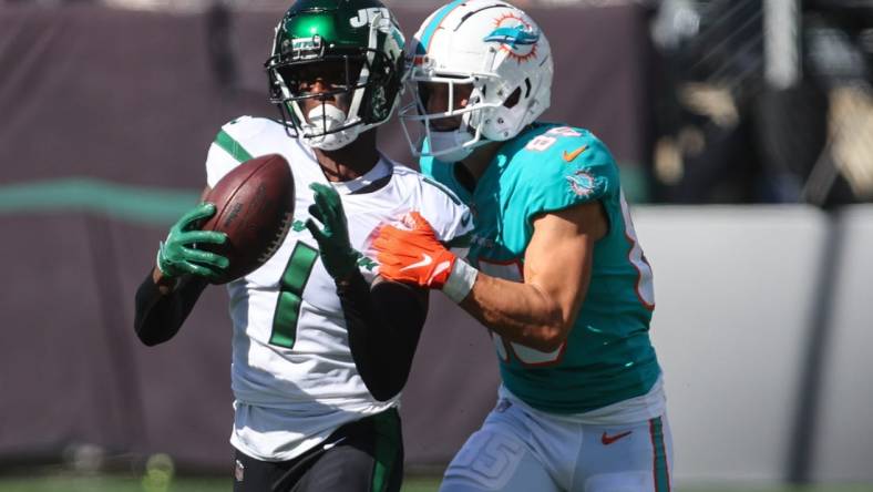 Oct 9, 2022; East Rutherford, New Jersey, USA; New York Jets cornerback Sauce Gardner (1) intercepts a pass intended for wide receiver River Cracraft (85) from quarterback Skylar Thompson (not shown) during the first half at MetLife Stadium. Mandatory Credit: Ed Mulholland-USA TODAY Sports