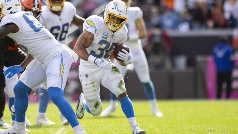 Oct 9, 2022; Cleveland, Ohio, USA; Los Angeles Chargers running back Austin Ekeler (30) runs the ball for a first down against the Cleveland Browns during the fourth quarter at FirstEnergy Stadium. Mandatory Credit: Scott Galvin-USA TODAY Sports