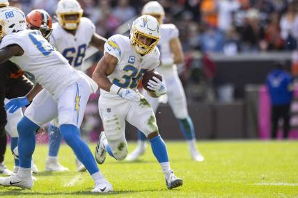 Oct 9, 2022; Cleveland, Ohio, USA; Los Angeles Chargers running back Austin Ekeler (30) runs the ball for a first down against the Cleveland Browns during the fourth quarter at FirstEnergy Stadium. Mandatory Credit: Scott Galvin-USA TODAY Sports