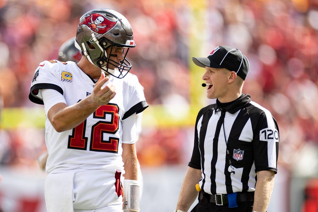 Oct 9, 2022; Tampa, Florida, USA; Tampa Bay Buccaneers quarterback Tom Brady (12) discusses a call with side judge Jonah Monroe (120) during the second half against the Atlanta Falcons at Raymond James Stadium. Mandatory Credit: Matt Pendleton-USA TODAY Sports