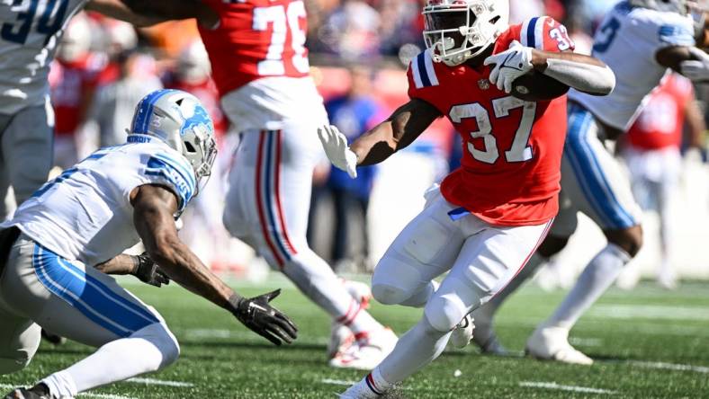 Oct 9, 2022; Foxborough, Massachusetts, USA; New England Patriots running back Damien Harris (37) runs against Detroit Lions safety DeShon Elliott (5) during the first half at Gillette Stadium. Mandatory Credit: Brian Fluharty-USA TODAY Sports