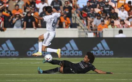 Oct 9, 2022; Houston, Texas, USA; Houston Dynamo FC midfielder Adalberto Carrasquilla (20) attempts to get control of the ball from LA Galaxy midfielder Riqui Puig (6) during the first half at PNC Stadium. Mandatory Credit: Troy Taormina-USA TODAY Sports