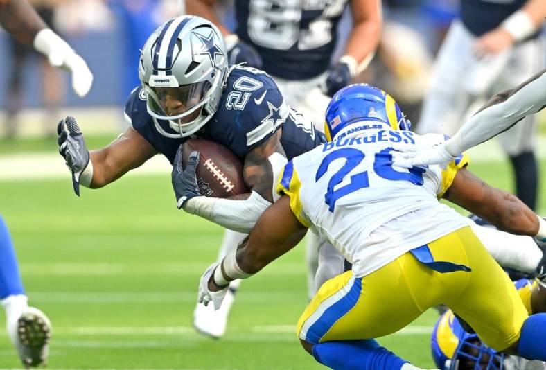 Oct 9, 2022; Inglewood, California, USA; Dallas Cowboys running back Tony Pollard (20) is stopped by Los Angeles Rams safety Terrell Burgess (26) after a short gain in the second half at SoFi Stadium. Mandatory Credit: Jayne Kamin-Oncea-USA TODAY Sports