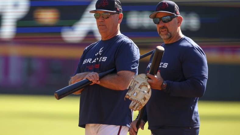 Oct 10, 2022; Atlanta, Georgia, USA; Atlanta Braves manager Brian Snitker (43) and bench coach Walt Weiss (4) during a team workout for the NLDS at Truist Park. Mandatory Credit: Brett Davis-USA TODAY Sports