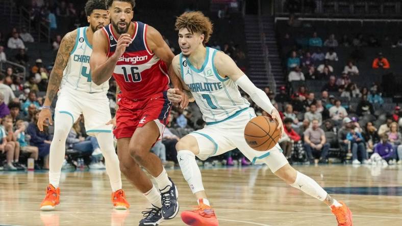 Oct 10, 2022; Charlotte, North Carolina, USA;  Charlotte Hornets guard LaMelo Ball (1) drives the lane against Washington Wizards forward Anthony Gill (16) during the second half at Spectrum Center. Mandatory Credit: Jim Dedmon-USA TODAY Sports