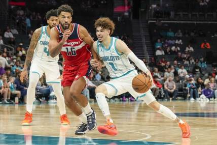 Oct 10, 2022; Charlotte, North Carolina, USA;  Charlotte Hornets guard LaMelo Ball (1) drives the lane against Washington Wizards forward Anthony Gill (16) during the second half at Spectrum Center. Mandatory Credit: Jim Dedmon-USA TODAY Sports