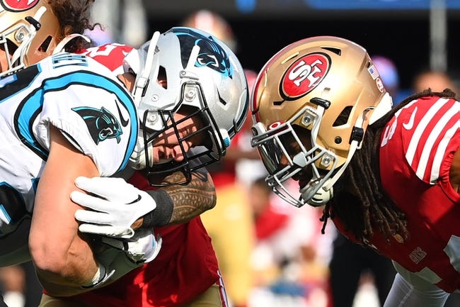 Oct 9, 2022; Charlotte, North Carolina, USA; Carolina Panthers running back Christian McCaffrey (22) is tackled by San Francisco 49ers safety Talanoa Hufanga (29) and linebacker Fred Warner (54) in the first quarter at Bank of America Stadium. Mandatory Credit: Bob Donnan-USA TODAY Sports