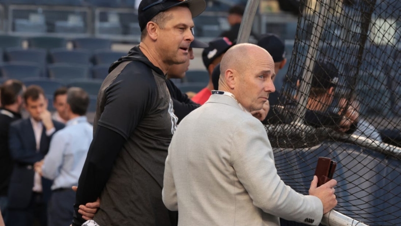 Oct 11, 2022; Bronx, New York, USA; New York Yankees manager Aaron Boone, left, and general manager Brian Cashman watch batting practice before game one of the ALDS against the Cleveland Guardians for the 2022 MLB Playoffs at Yankee Stadium. Mandatory Credit: Vincent Carchietta-USA TODAY Sports
