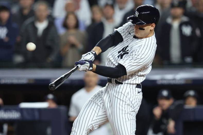 Oct 11, 2022; Bronx, New York, USA;   New York Yankees first baseman Anthony Rizzo (48) hits a home run during the sixth inning against the Cleveland Guardians iin game one of the ALDS for the 2022 MLB Playoffs at Yankee Stadium. Mandatory Credit: Brad Penner-USA TODAY Sports