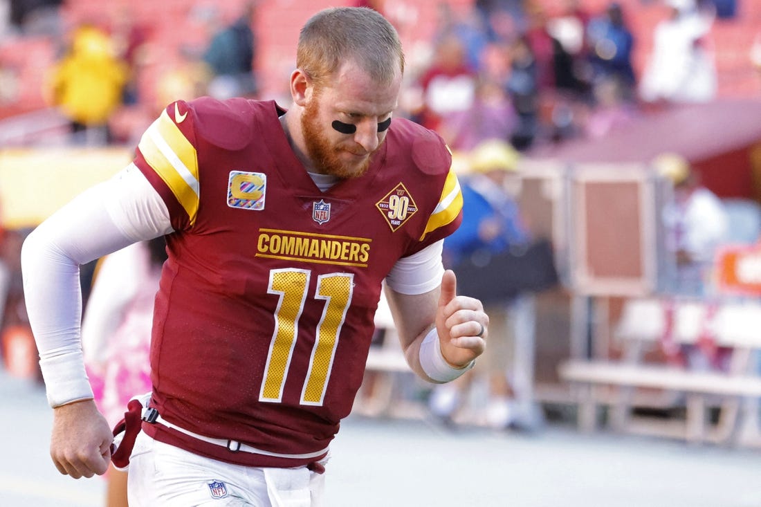 Oct 9, 2022; Landover, Maryland, USA; Washington Commanders quarterback Carson Wentz (11) jogs off the field after the Commanders' game against the Tennessee Titans at FedExField. Mandatory Credit: Geoff Burke-USA TODAY Sports