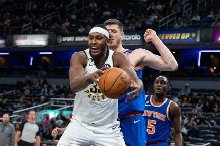 Oct 12, 2022; Indianapolis, Indiana, USA; Indiana Pacers center Myles Turner (33) rebounds the ball over New York Knicks center Isaiah Hartenstein (55) in the first half at Gainbridge Fieldhouse. Mandatory Credit: Trevor Ruszkowski-USA TODAY Sports
