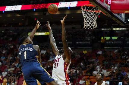 Oct 12, 2022; Miami, Florida, USA; New Orleans Pelicans forward Zion Williamson (1) lays the ball up against Miami Heat center Dewayne Dedmon (21) during the first quarter at FTX Arena. Mandatory Credit: Rich Storry-USA TODAY Sports