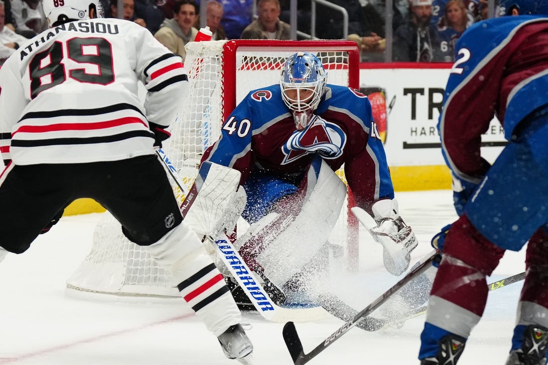 Oct 12, 2022; Denver, Colorado, USA; Colorado Avalanche goaltender Alexandar Georgiev (40) defends his net against Chicago Blackhawks center Andreas Athanasiou (89) in the first period at Ball Arena. Mandatory Credit: Ron Chenoy-USA TODAY Sports