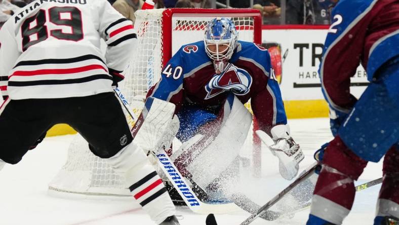 Oct 12, 2022; Denver, Colorado, USA; Colorado Avalanche goaltender Alexandar Georgiev (40) defends his net against Chicago Blackhawks center Andreas Athanasiou (89) in the first period at Ball Arena. Mandatory Credit: Ron Chenoy-USA TODAY Sports