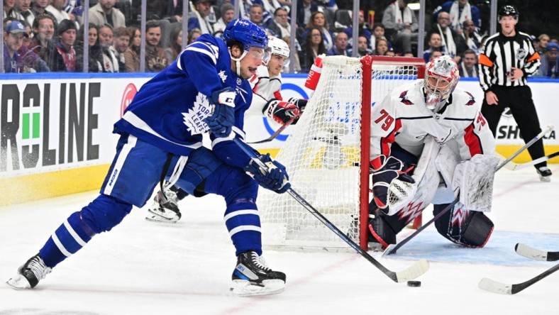 Oct 13, 2022; Toronto, Ontario, CAN;  Toronto Maple Leafs forward Auston Matthews (34) shoots as Washington Capitals goalie Charlie Lindgren (79) defends in the first period at Scotiabank Arena. Mandatory Credit: Dan Hamilton-USA TODAY Sports