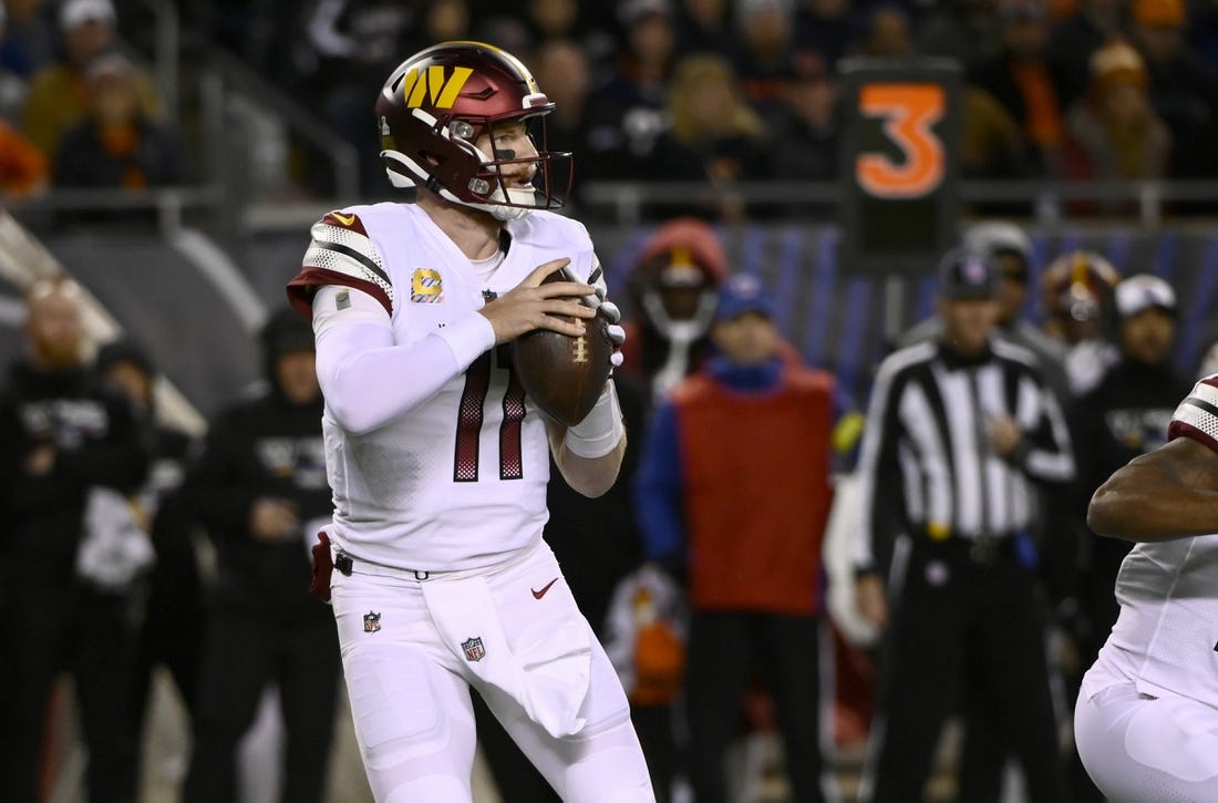 Oct 13, 2022; Chicago, Illinois, USA; Washington Commanders quarterback Carson Wentz (11) looks to pass against the Chicago Bears during the first half at Soldier Field. Mandatory Credit: Matt Marton-USA TODAY Sports